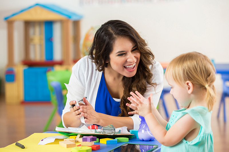 Childcare Lady With Little Girl Smilung